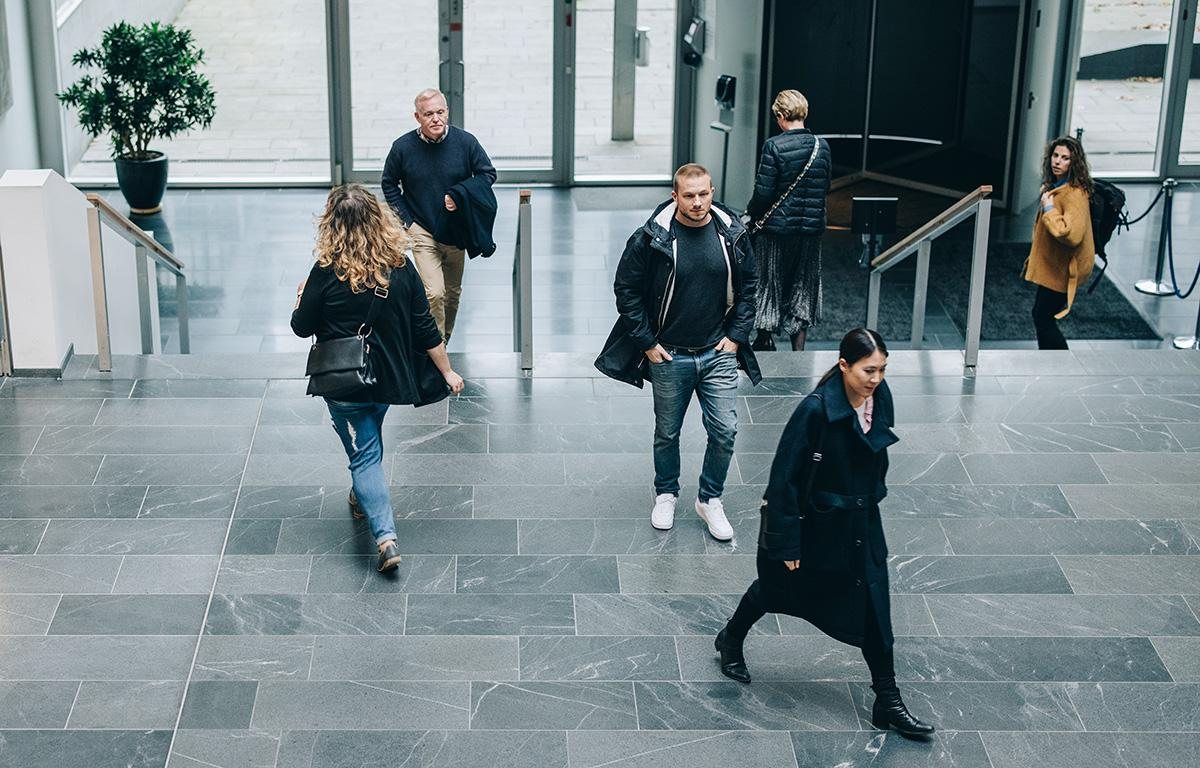 People walking through the lobby of an office building