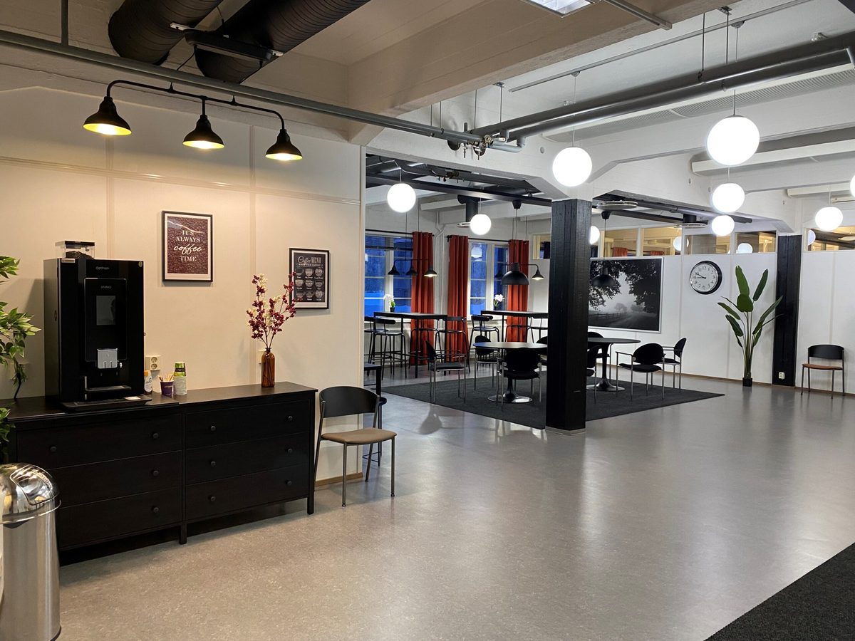 The CatMarina coworking lounge: coffee machine, high tables and seating under pendant lights