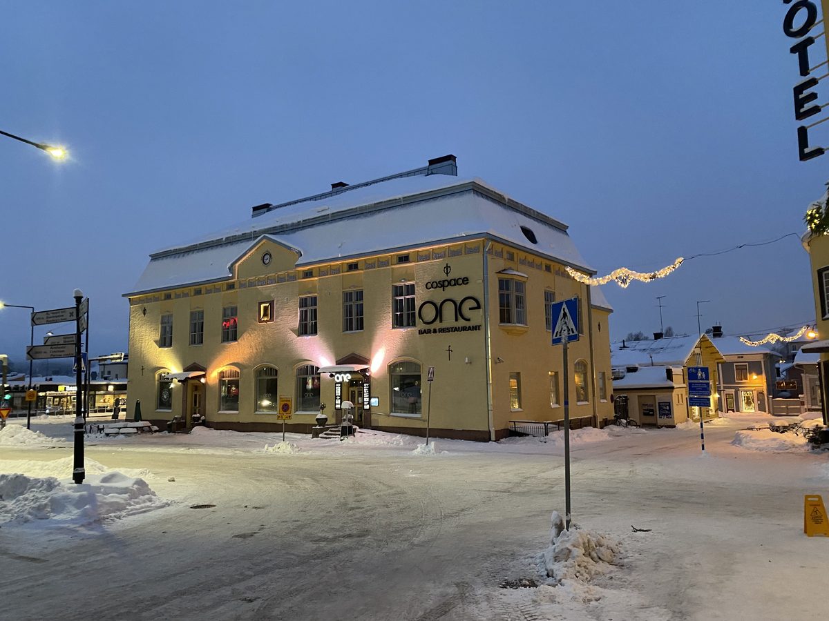 The CoSpace ONE building in the centre of Porvoo on a winter evening, lit up in the snow